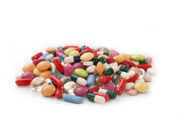 Many colorful pills isolated on white background