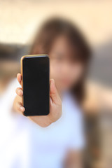Woman holding smart phone in hand