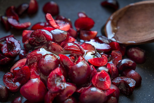 Fresh Red Cherries with Honey and in Cast-iron Pan with Wooden Spoon, Dark Food Photography, Red Berry Sauce for Meat