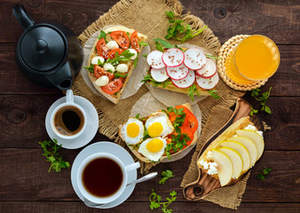 Many kinds of sandwiches, bruschetta, and tea, coffee, fresh juice - for a family breakfast. The top view