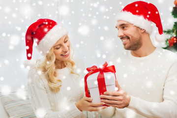 happy couple at home with christmas gift box