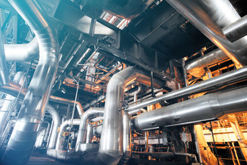 Equipment, cables and piping as found inside of a modern industr