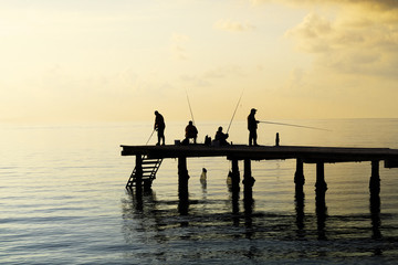 Naklejka na ściany i meble Local fishermen catch fish from the pier.