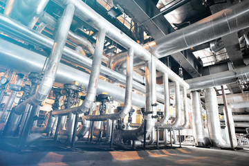 Equipment, cables and piping as found inside of a modern industr