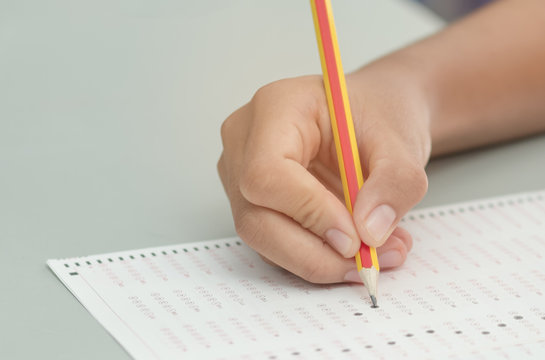 student testing in exercise, exams answer sheets with pencil