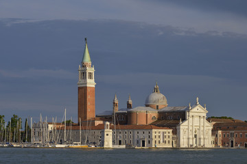 Fototapeta na wymiar Basilica of San Giorgio Maggiore and the port in Venice, a famous city in northeastern Italy and the capital of the Veneto region
