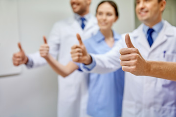 Fototapeta na wymiar close up of doctors at hospital showing thumbs