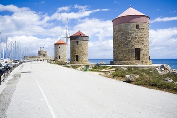 Fototapeta na wymiar Windmills at Mandraki port, Rhodes