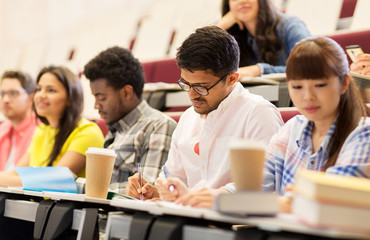 group of students with coffee writing on lecture