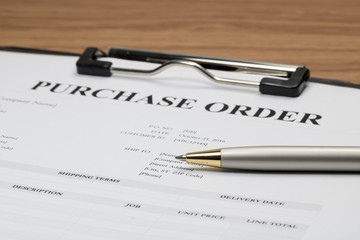 Close up of purchase order form with pen  / selective focus