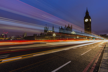 Fototapeta na wymiar London, England, UK. Red buses blured in motion on Westminster b