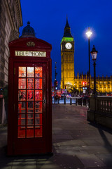 Fototapeta na wymiar Famous English red telephone boxes with Big Ben in London at nig