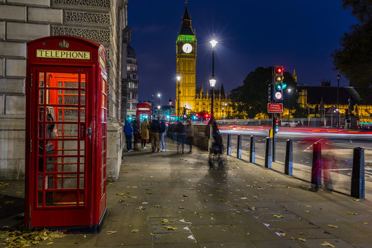 Famous English red telephone boxes with Big Ben in London at nig - Powered by Adobe