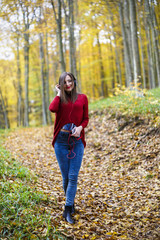 Young caucasian brunette woman with headphones outdoors on autum