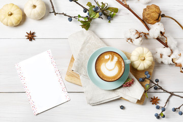 Pumpkin spice latte. Coffee top view on white wood background