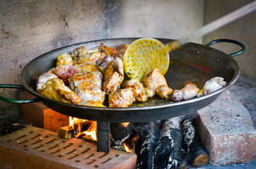 Making traditional Spanish Paella over open fire with wood  coal