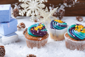 Wintery cupcakes on a snow background