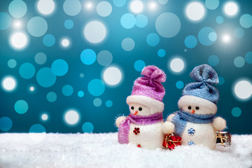 Couple of snowmen on blue winter background