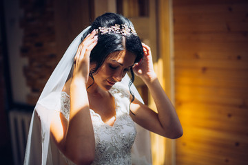 Bride and bridesmaids during the wedding preparations. Woman with perfume aroma spray.
