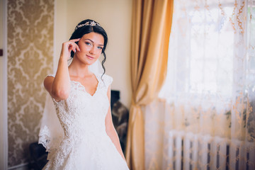 Luxury bride on the morning of wedding day. Wedding jewelry. soft selective focus. gorgeous young woman at home prepare to wedding day