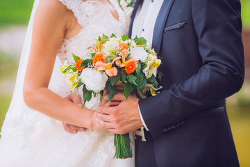 close-up of colorful wedding bouquet at bride's hands