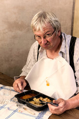 Grumpy man with tv dinner