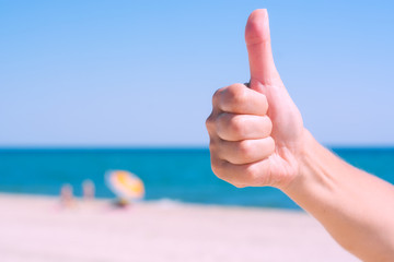 Woman's hand showing thumbs up