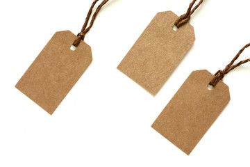 blank tag tied with a brown string on a white background 
