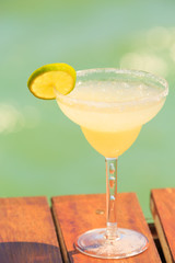 Margarita cocktail on the wooden pier. Concept of classic drink.