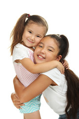 Happy funny girl sisters hugging  isolated on a white background