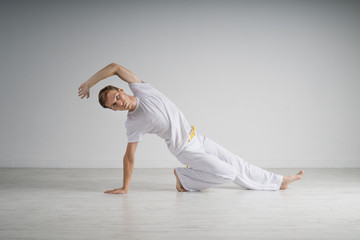 Naklejka premium Man practicing Capoeira , brazilian martial Art.