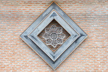 Traditional Thai style craving on the brick wall.