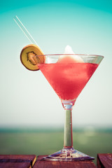 Frozen Strawberry Daiquiri cocktail on the wooden pier. Concept