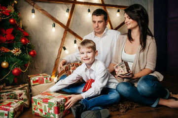 happy young family in Christmas decorations