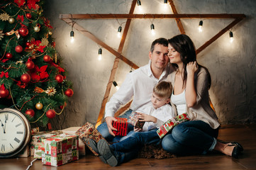 Obraz na płótnie Canvas happy young family in Christmas decorations