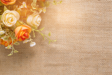 Fabric color roses flower on sackcloth with light with copy space