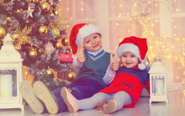 Fototapeta na wymiar happy kids waiting for christmas presents in decorated living room