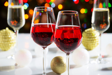 Red wine glasses and christmas balls
