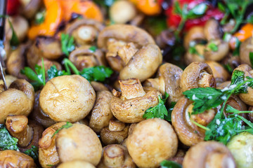 Champignon white mushrooms grilled on grill or BBQ steam and small drops of water. Cooking mushrooms on the grill. Portobello mushrooms marinated and grilling. Grilled vegetables on a grill close up.