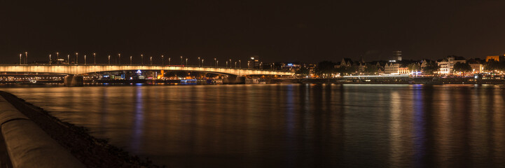 Fototapeta na wymiar Illuminated bridge of Deutz by night, Cologne, Germany