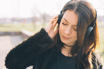 young beautiful woman listening to music with headphones