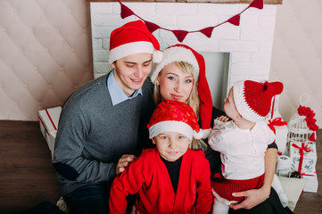 Fototapeta premium Portrait of friendly family looking at camera on Christmas evening