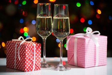 Glasses of wine and christmas gifts