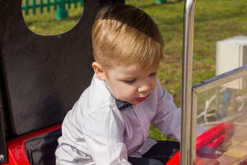 Little boy is riding the car