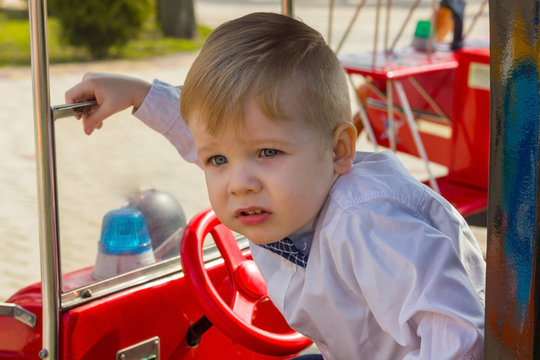 Close-up photo of little boy in the car