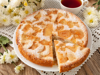 Delicious apple pie and chrysanthemums on old blackboard