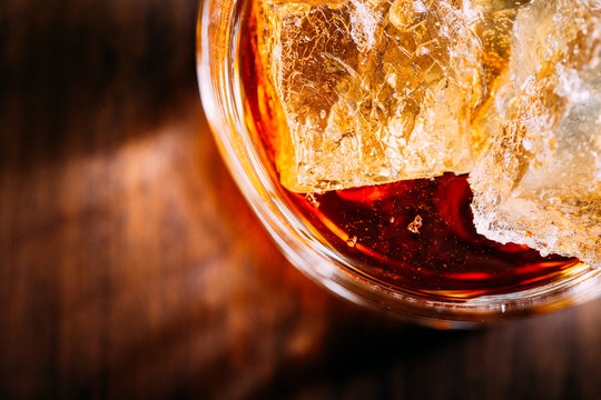 Glass of whiskey on a wooden table