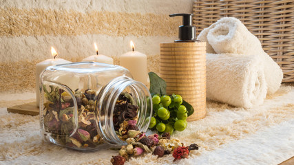 SPA concept - candles, towels, oil and herbs