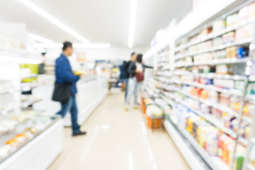 Fototapeta premium Shelf blurred of modern supermarket with people