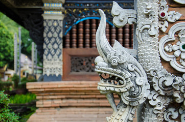 Fototapeta na wymiar Stucco Head of Thai Traditional Art Serpent King of Naga and Flower (Lai Thai) Handmade Background Wallpaper